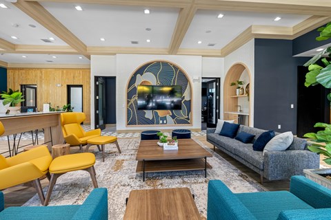 a living room with blue couches and yellow chairs